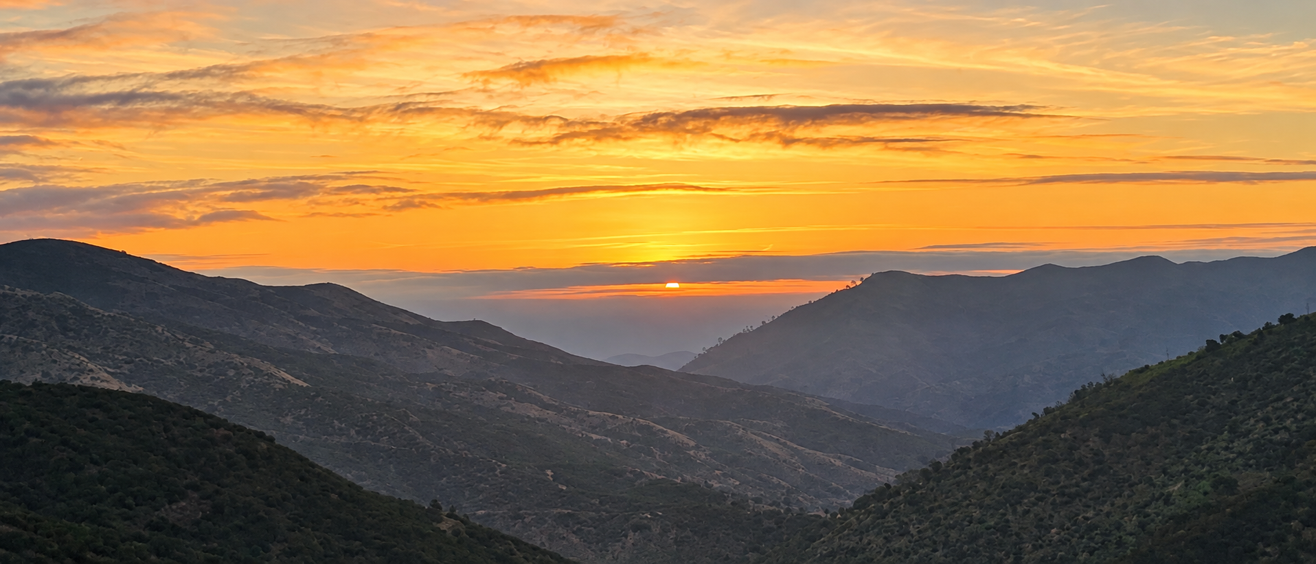 Golden sunrise over the layered ridges of Del Puerto Canyon