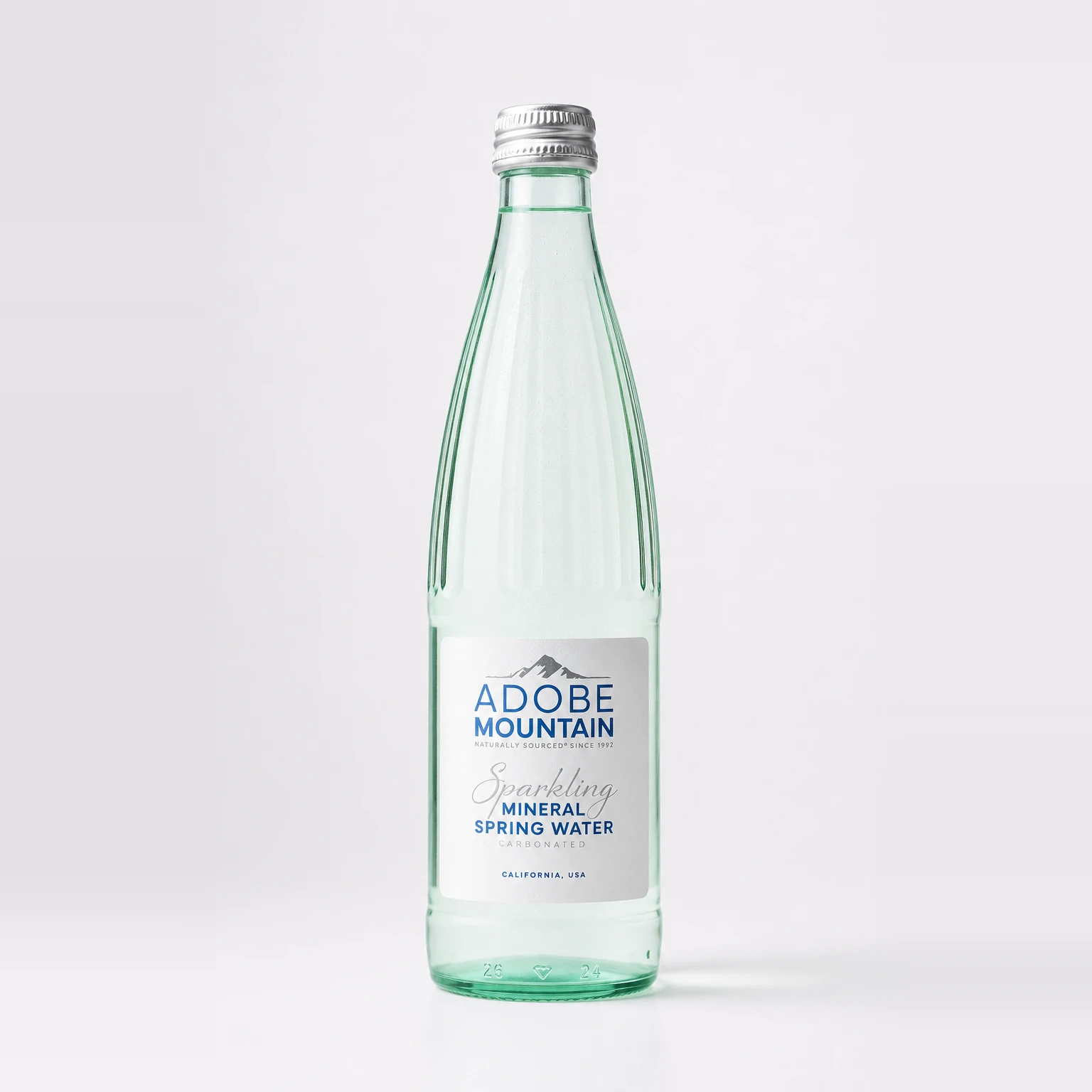 Adobe Mountain sparkling mineral spring water in a clear glass bottle with its front label facing forward