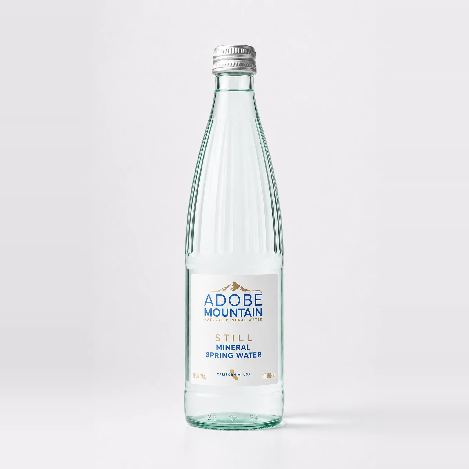 Adobe Mountain still mineral spring water in a clear glass bottle with its front label facing forward